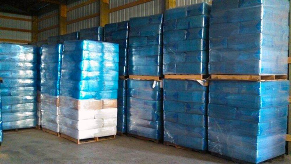 Jim Thorp Lumber trucks loaded with wrapped pallets
